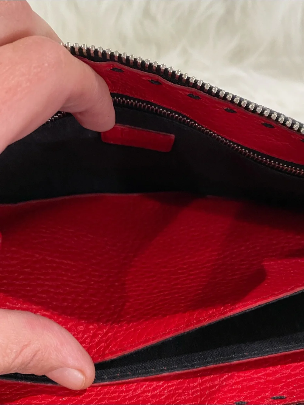 Fendi Selleria flat clutch bag with red stitching and red leather handle